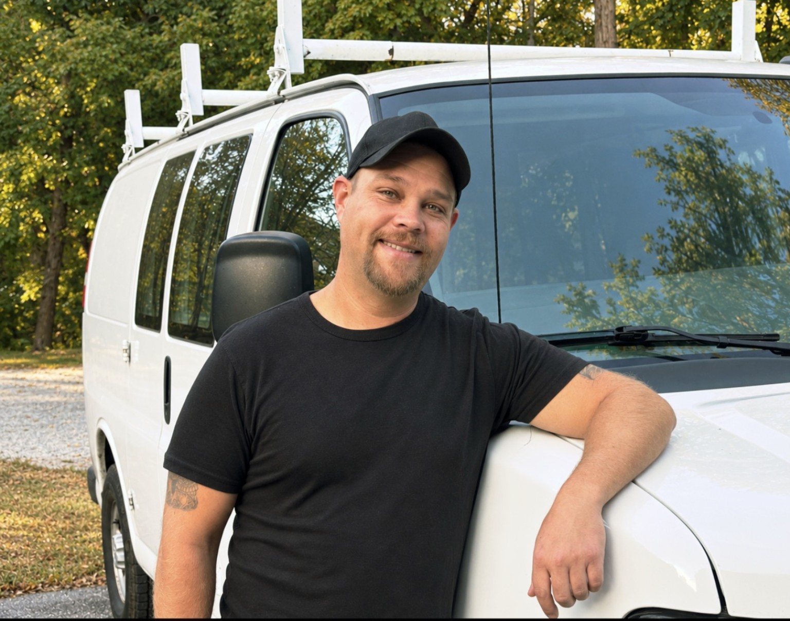 Keegan Barnicle beside a TKO work van.
